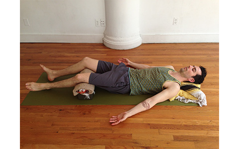 Photo: Man demonstrates Savasana yoga pose