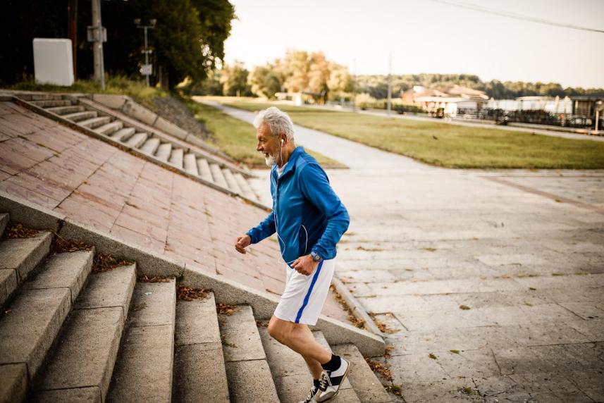 Older man jogging up stairs