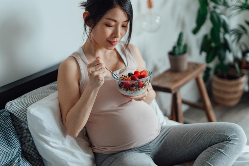 pregnant woman eating yogurt