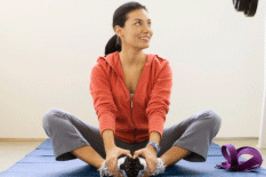 Photo: Woman stretching on yoga mat