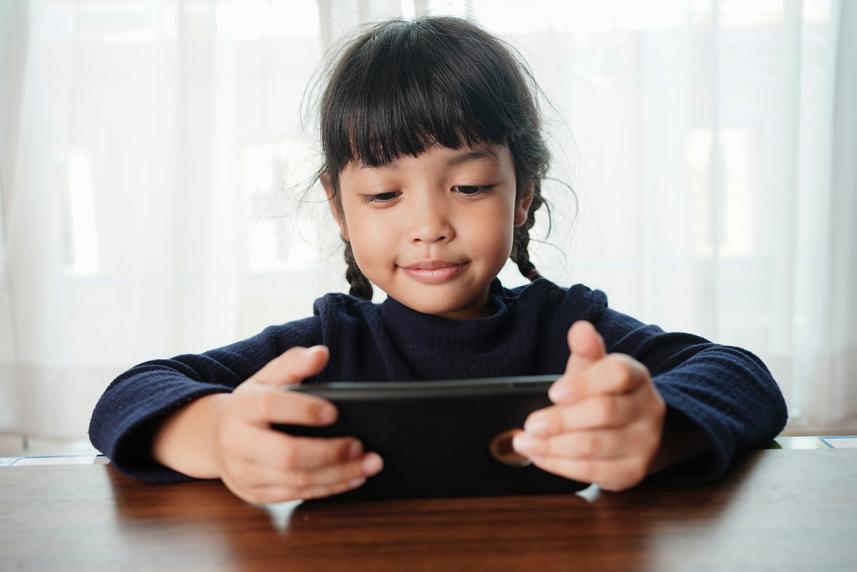 Child playing on a smartphone. 