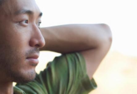 Photo: Man relaxing with arms crossed behind his head