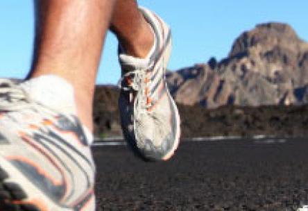 Photo: Close-up of running feet with mountain in background
