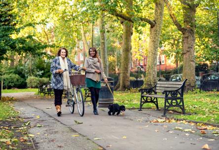 Two women walking in a park