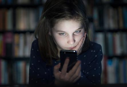 child looking at smartphone