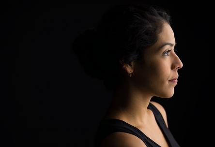 Woman behind a dark background