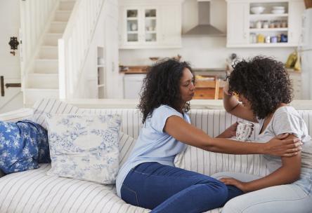 mom comforting daughter
