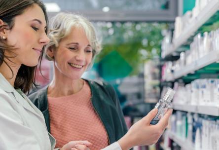 older woman looking at prescriptions