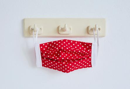 Face mask hanging on wall hooks.