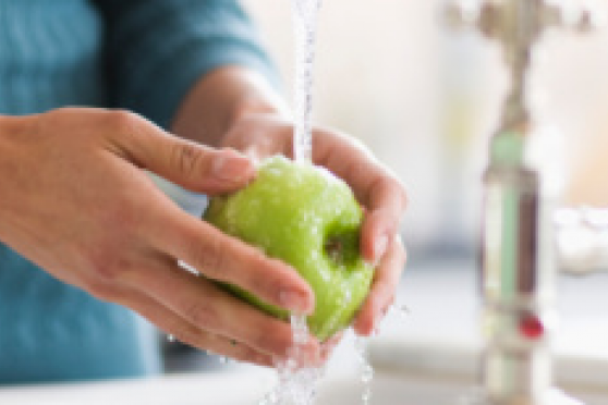Photo: Woman washing a green apple