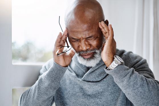 A older gentleman gets a stress-related headache. 